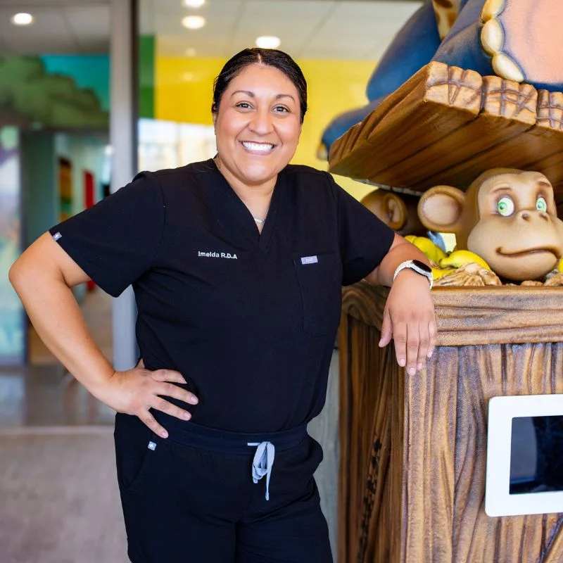 Friendly staff showing child around dental office during preview tour